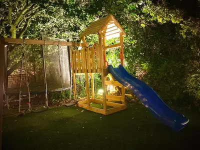 a playground with a blue slide and a gazebo at Beautiful Hot Tub Suite in Lytham St Annes in Lytham St Annes