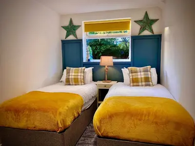 two beds in a room with stars on the wall at Beautiful Hot Tub Suite in Lytham St Annes in Lytham St Annes
