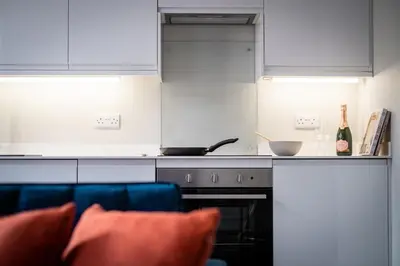 a kitchen with white cabinets and a stove top oven at Dalton Sq Apartments in Lancaster