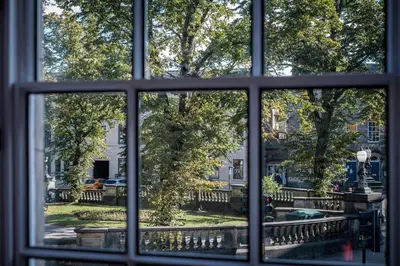 a window view of a park from a house at Dalton Sq Apartments in Lancaster