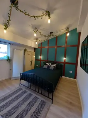a bedroom with a bed and a green wall at L2 Apartments- City Center- 2 bed in Liverpool