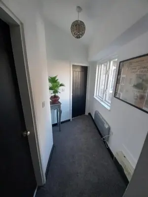 an empty hallway with a table and a potted plant at L2 Apartments- City Center- 2 bed in Liverpool