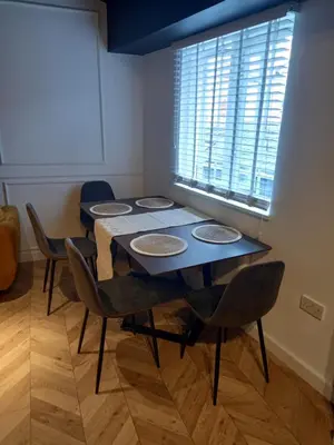 a room with a table with chairs and a window at L2 Apartments- City Center- 2 bed in Liverpool