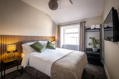 a bedroom with a large bed and a window at Dalton Sq Apartment 2 in Lancaster