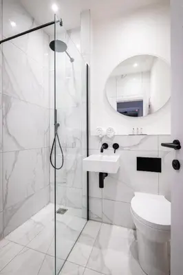 a bathroom with a shower and a toilet and a sink at Dalton Sq Apartment 2 in Lancaster
