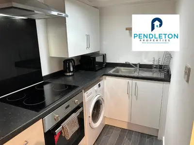 a kitchen with a sink and a washing machine at Cosy Central APT, 10 Min Walk to UCLAN and Library in Preston