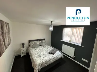 a bedroom with a bed and a sign on the wall at Cosy Central APT, 10 Min Walk to UCLAN and Library in Preston