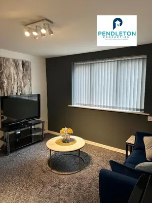 a living room with a tv and a coffee table at Cosy Central APT, 10 Min Walk to UCLAN and Library in Preston