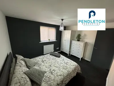 a bedroom with a bed and a black wall at Cosy Central APT, 10 Min Walk to UCLAN and Library in Preston