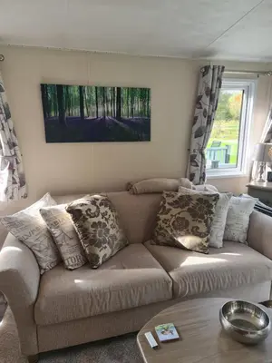 a living room with a brown couch with pillows at Nicks and Carmels by the Lake in Carnforth