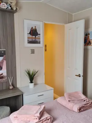 a bedroom with two pink towels on a bed at Nicks and Carmels by the Lake in Carnforth