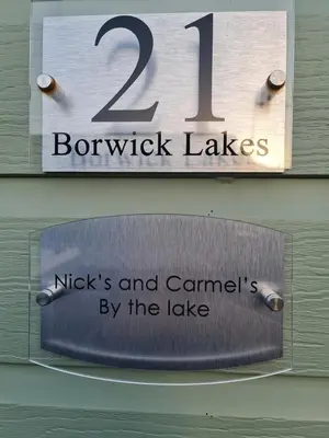 a sign that reads nights and camped by the lake at Nicks and Carmels by the Lake in Carnforth