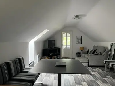 a living room with a couch and a table at Green Little Acre in Little Singleton
