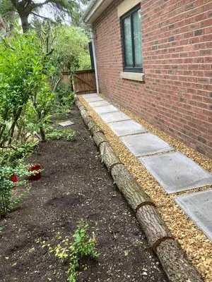 a garden next to a brick building at Green Little Acre in Little Singleton