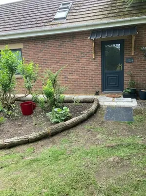 a house with a yard with plants and a door at Green Little Acre in Little Singleton