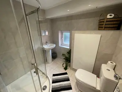a bathroom with a shower and a toilet and a sink at Deluxe Huge Detached House with Parking, sleeps up to 30 people, 2m from Liverpool City Centre in Liverpool