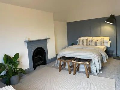 a bedroom with a bed and a fireplace at Deluxe Huge Detached House with Parking, sleeps up to 30 people, 2m from Liverpool City Centre in Liverpool