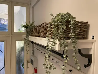 a wine rack with a bunch of plants on it at Deluxe Huge Detached House with Parking, sleeps up to 30 people, 2m from Liverpool City Centre in Liverpool