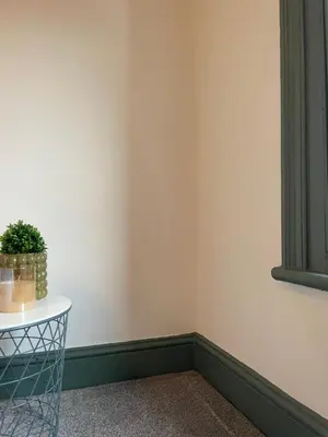 a corner of a room with a table with a potted plant at Deluxe Huge Detached House with Parking, sleeps up to 30 people, 2m from Liverpool City Centre in Liverpool