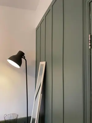 a floor lamp and a ladder next to a wall at Deluxe Huge Detached House with Parking, sleeps up to 30 people, 2m from Liverpool City Centre in Liverpool