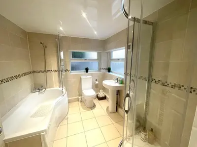 a bathroom with a toilet and a sink and a shower at Deluxe Huge Detached House with Parking, sleeps up to 30 people, 2m from Liverpool City Centre in Liverpool