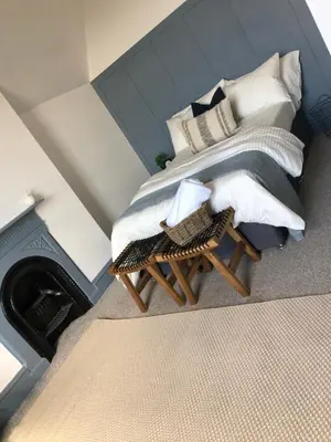 a bedroom with a bed with pillows and a table at Deluxe Huge Detached House with Parking, sleeps up to 30 people, 2m from Liverpool City Centre in Liverpool
