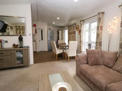 a living room with a couch and a table at 3 Yealands in Carnforth