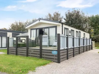 a small house with a black fence at 3 Yealands in Carnforth