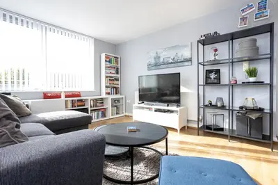 a living room with a couch and a tv at GuestReady - Modern stay in Bispham House in Liverpool