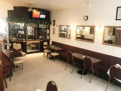 a dining room with tables and chairs and mirrors at Aysgarth House in Blackpool