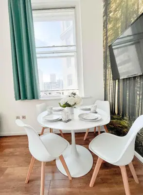 a white table and chairs in a room with a window at Duplex 2-bedroom apartment in Liverpool centre in Liverpool