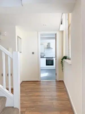 a hallway with white walls and a staircase with wood floors at Duplex 2-bedroom apartment in Liverpool centre in Liverpool