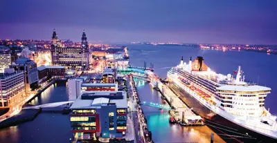 a large cruise ship docked in a harbor at night at Duplex 2-bedroom apartment in Liverpool centre in Liverpool