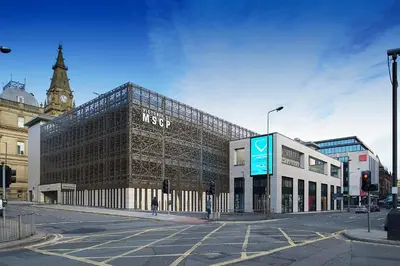 a large glass building on a city street at Duplex 2-bedroom apartment in Liverpool centre in Liverpool