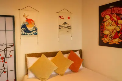 a bedroom with a bed with orange and white pillows at Sidemersey Livings- Convenient 1-Bedroom Flat with a View, Central Liverpool in Liverpool