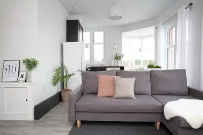 a living room with a gray couch in a room at Beautiful first floor apartment in Poulton le Fylde
