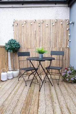 a table and two chairs on a wooden deck at Beautiful first floor apartment in Poulton le Fylde