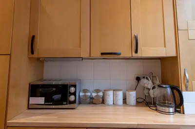 a kitchen counter with a microwave on a counter top at Beech Apparent lovely spacious double room in Liverpool