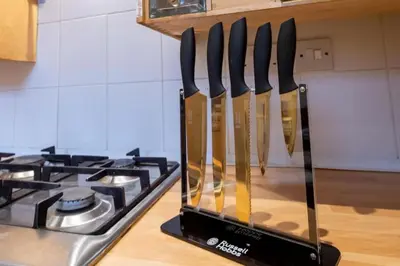 a group of knives on a counter next to a stove at Beech Apparent lovely spacious double room in Liverpool