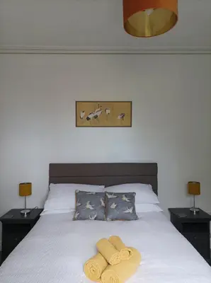 a bedroom with a bed with two towels on it at Victorian Renovation Room 1 in Liverpool