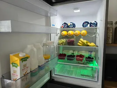 an open refrigerator filled with milk and fruit and juice at Victorian Renovation Room 1 in Liverpool