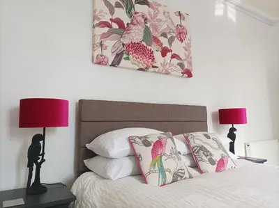 a bedroom with a bed with pillows and two lamps at Victorian Renovation Room 3 in Liverpool