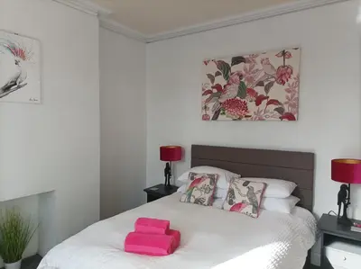 a bedroom with a bed with pink towels on it at Victorian Renovation Room 3 in Liverpool