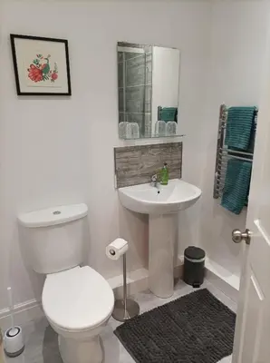 a white bathroom with a toilet and a sink at Victorian Renovation Room 4 in Liverpool