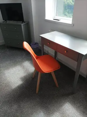 a desk and a red chair in a room at Victorian Renovation Room 6 in Liverpool