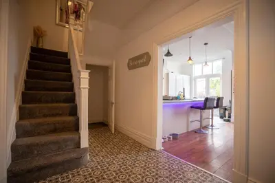 a hallway with a staircase in a house at Cavendish Cat and Gaming House in Blackpool