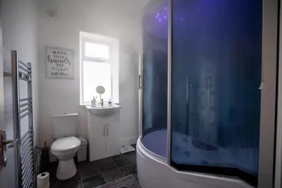a bathroom with a shower and a toilet at Cavendish Cat and Gaming House in Blackpool