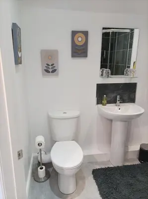 a white bathroom with a toilet and a sink at Victorian Renovation Room 8 in Liverpool