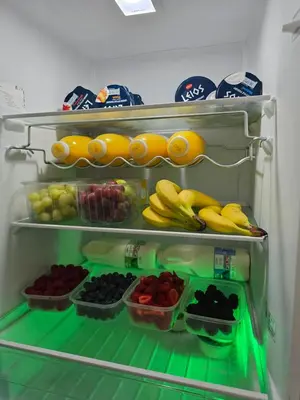 an open refrigerator filled with fruits and vegetables at Victorian Renovation Room 8 in Liverpool