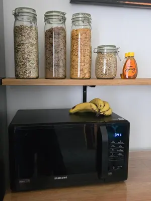 a black microwave with some bananas on top of it at Victorian Renovation Room 8 in Liverpool